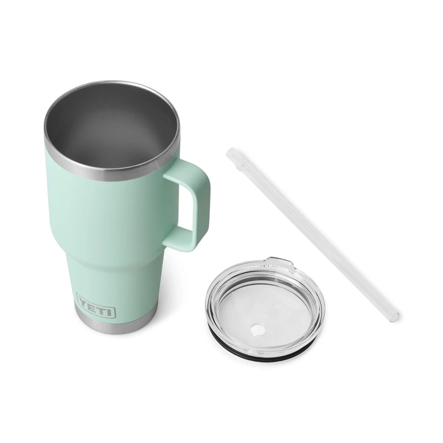 Mint green Yeti travel mug with lid and straw, ideal for camping and outdoor adventures.