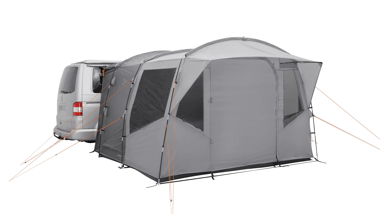 Gray motorhome awning attached to van, featuring mesh windows and orange guy lines for outdoor camping.