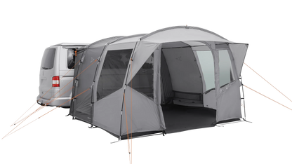 Gray motorhome awning with orange guy lines attached to van for outdoor camping setup