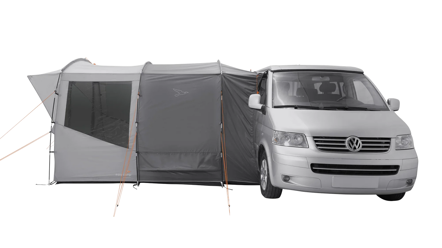 Gray motorhome awning attached to a silver van for camping adventures