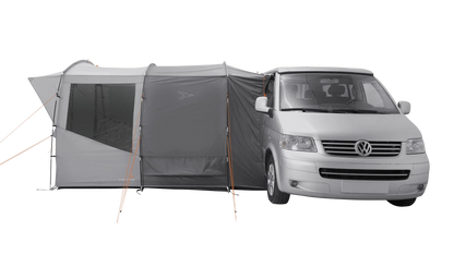 Gray motorhome awning attached to a silver van for camping adventures