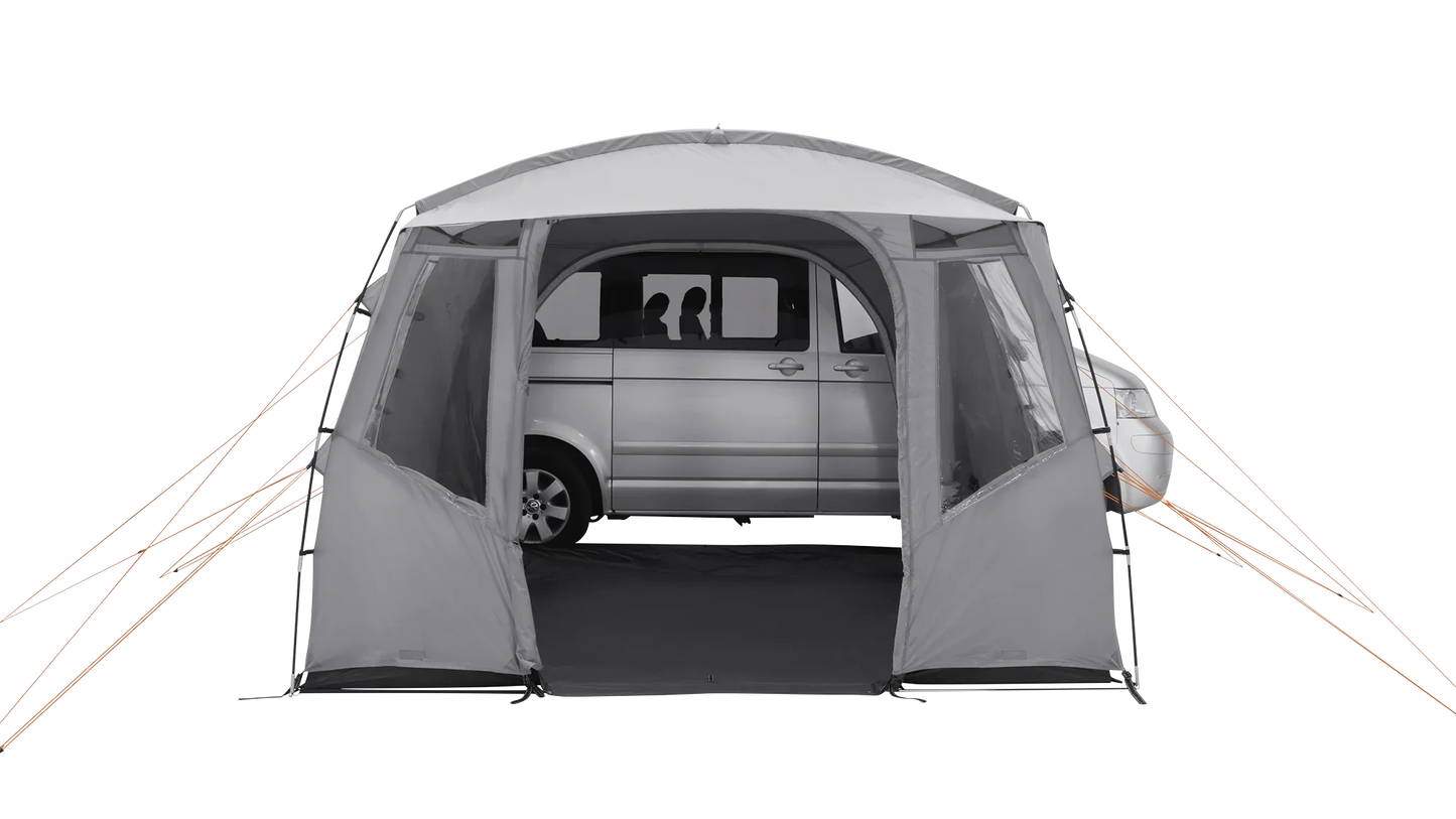 Gray motorhome awning with orange guy lines, providing shelter for a van