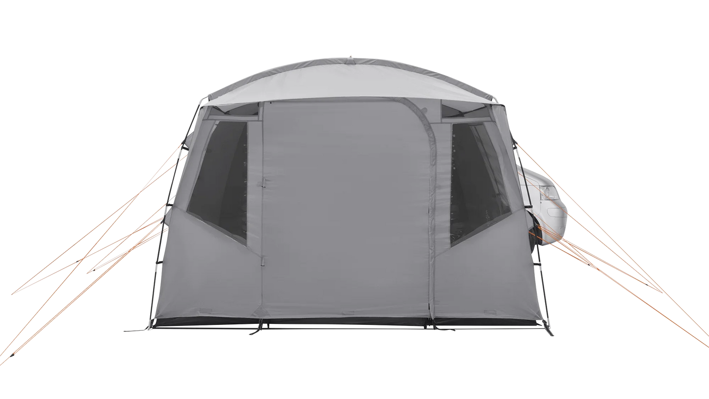 Gray caravan awning with orange guy lines attached to a vehicle for outdoor camping adventures