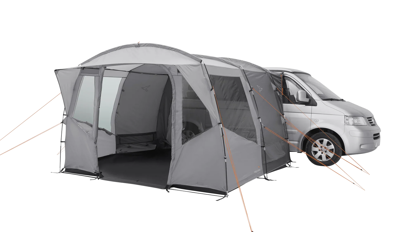 Gray motorhome awning attached to van, featuring mesh windows and orange guy lines for outdoor camping.