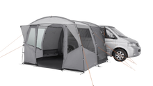 Gray motorhome awning attached to van, featuring mesh windows and orange guy lines for outdoor camping.