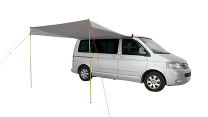 Motorhome awning attached to silver van for outdoor camping adventures