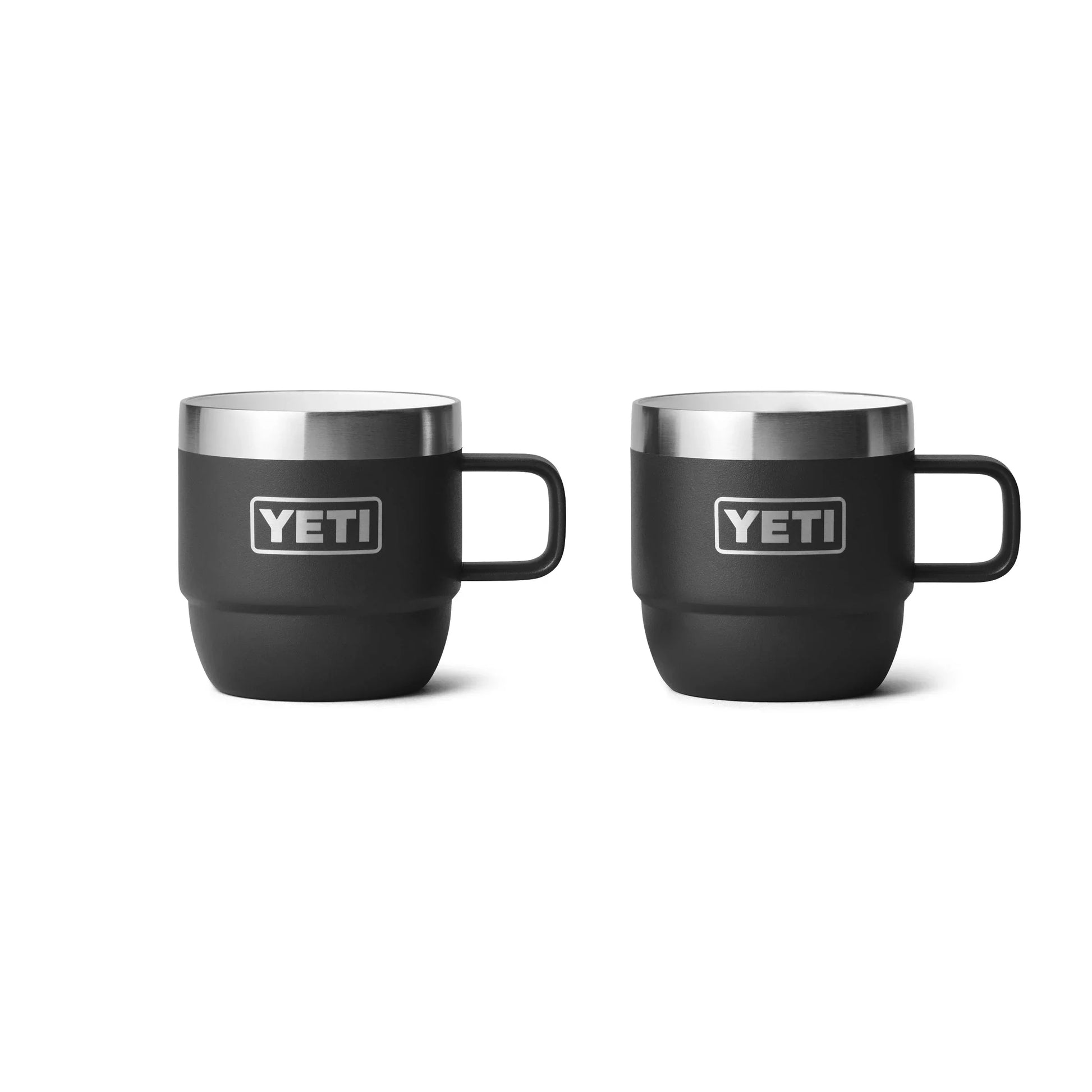 Two black YETI insulated mugs with handles, perfect for camping and outdoor adventures.