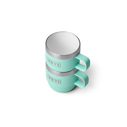 Mint green YETI insulated camping mugs with stainless steel rims, ideal for outdoor adventures.