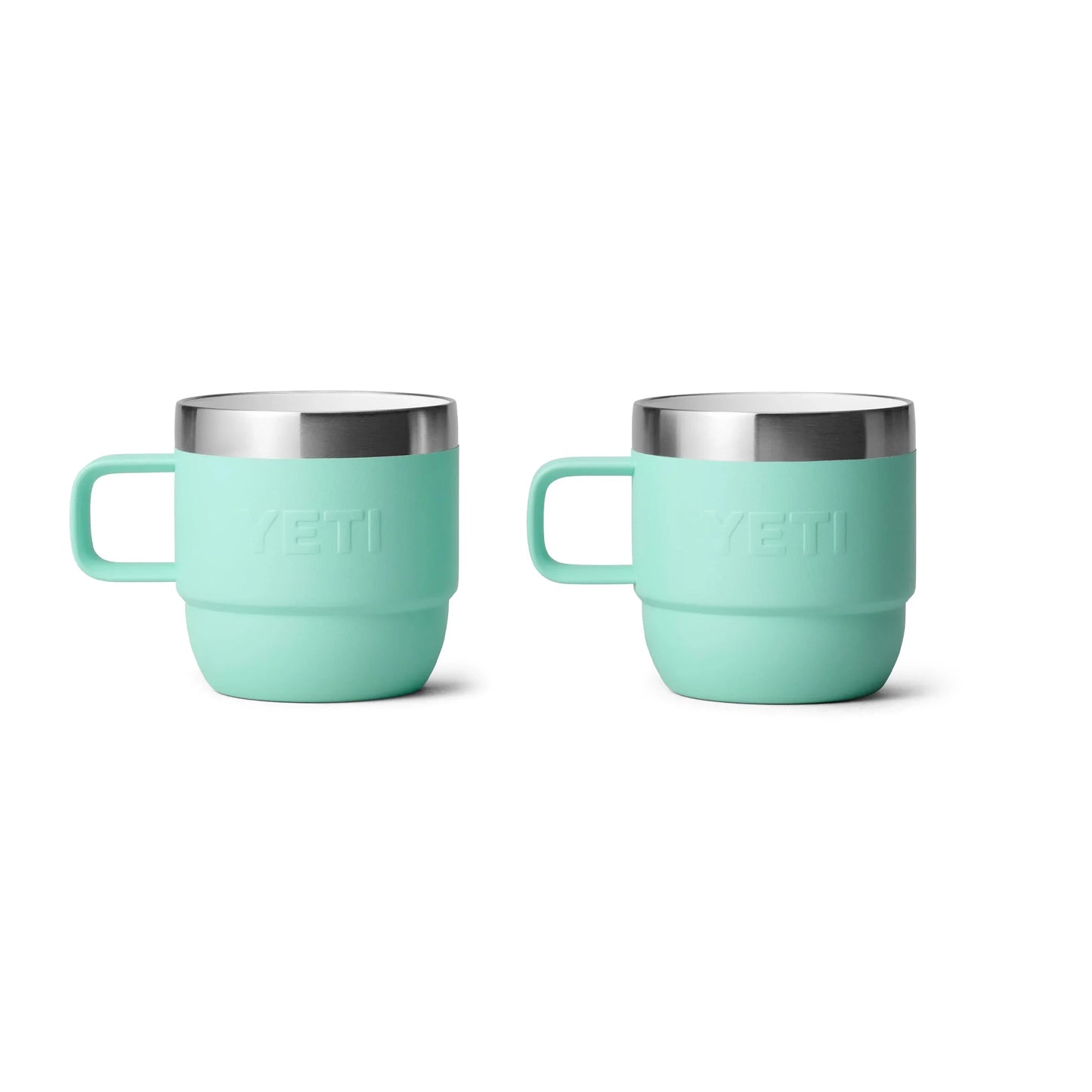 Mint green Yeti insulated mugs with stainless steel rims, ideal for camping and outdoor adventures.