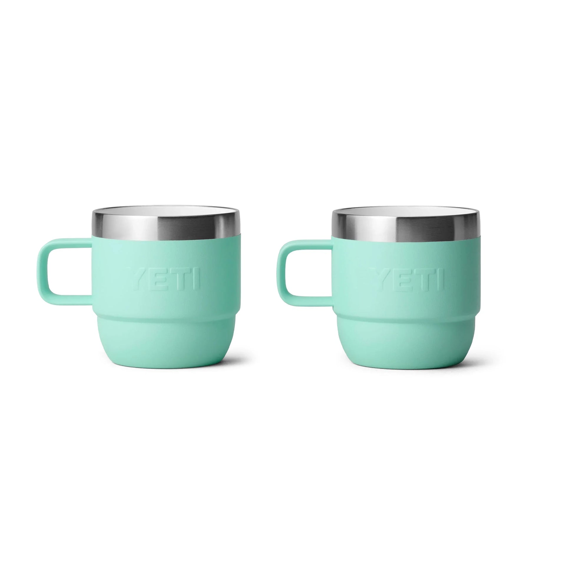 Mint green Yeti insulated mugs with stainless steel rims, ideal for camping and outdoor adventures.