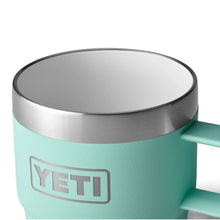Mint green YETI insulated mug with stainless steel rim and handle for outdoor adventures