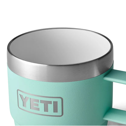 Mint green YETI insulated mug with stainless steel rim and handle for outdoor adventures