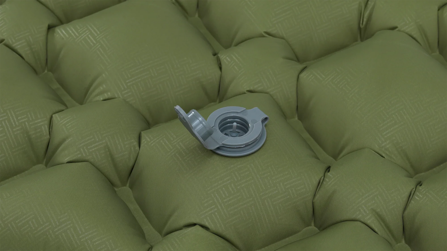 Green inflatable camping mattress with gray valve for outdoor adventures