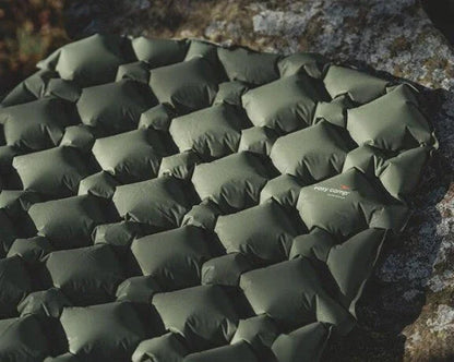 Olive green camping sleeping pad with hexagonal design, ideal for outdoor adventures and caravanning.