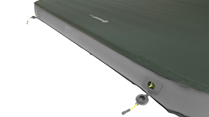 Green inflatable camping mattress with dual air valves for quick setup