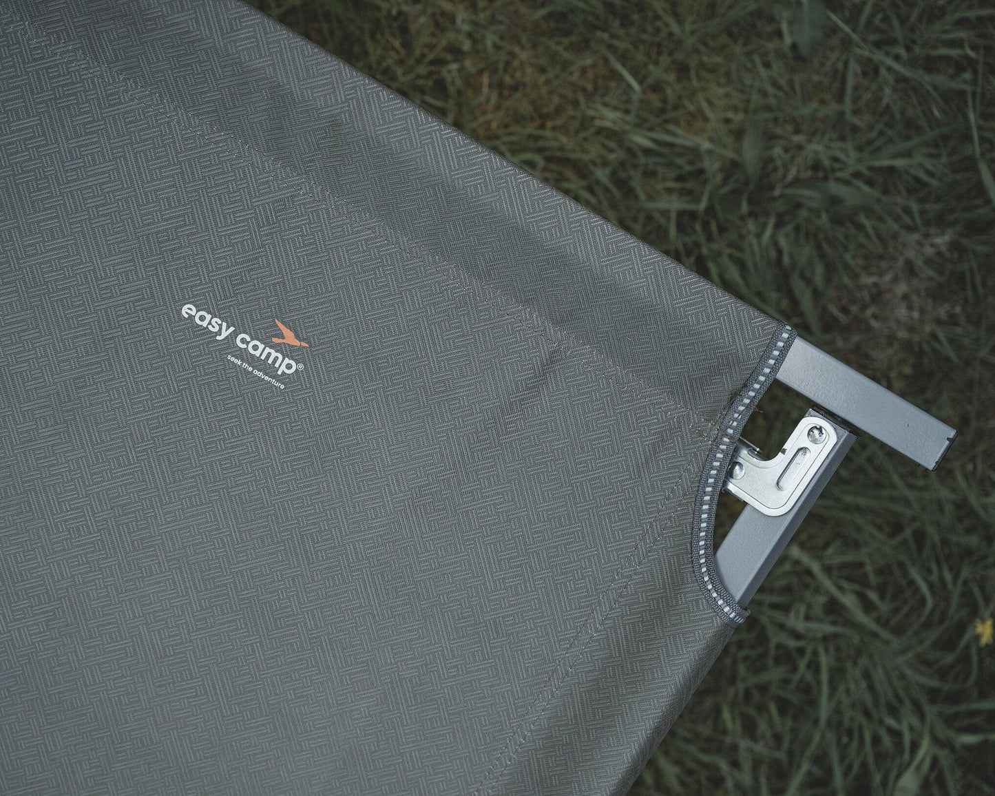 Easy Camp camping chair with textured fabric and metal frame on grass