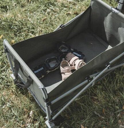 Foldable camping wagon with gear on grass, ideal for outdoor adventures and camping trips
