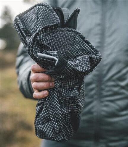 Compact camping gear bag with grid pattern, ideal for outdoor adventures and travel storage.