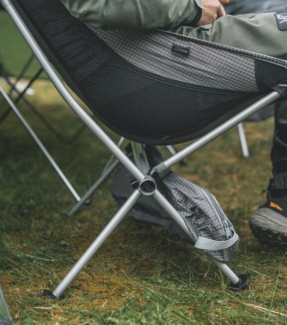 Portable camping chair with mesh back and carry bag, ideal for outdoor adventures and caravanning trips.