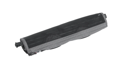 Compact rolled camping awning with gray grid trim, ideal for caravans and motorhomes
