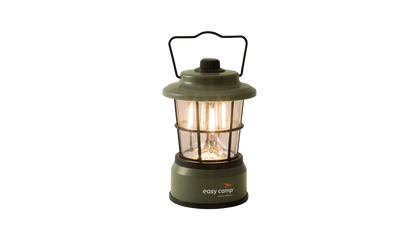 Green Easy Camp lantern with warm glow, ideal for camping and outdoor adventures.