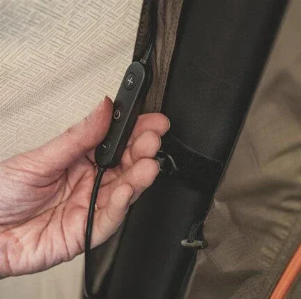 Hand adjusting control panel on camping gear with power buttons