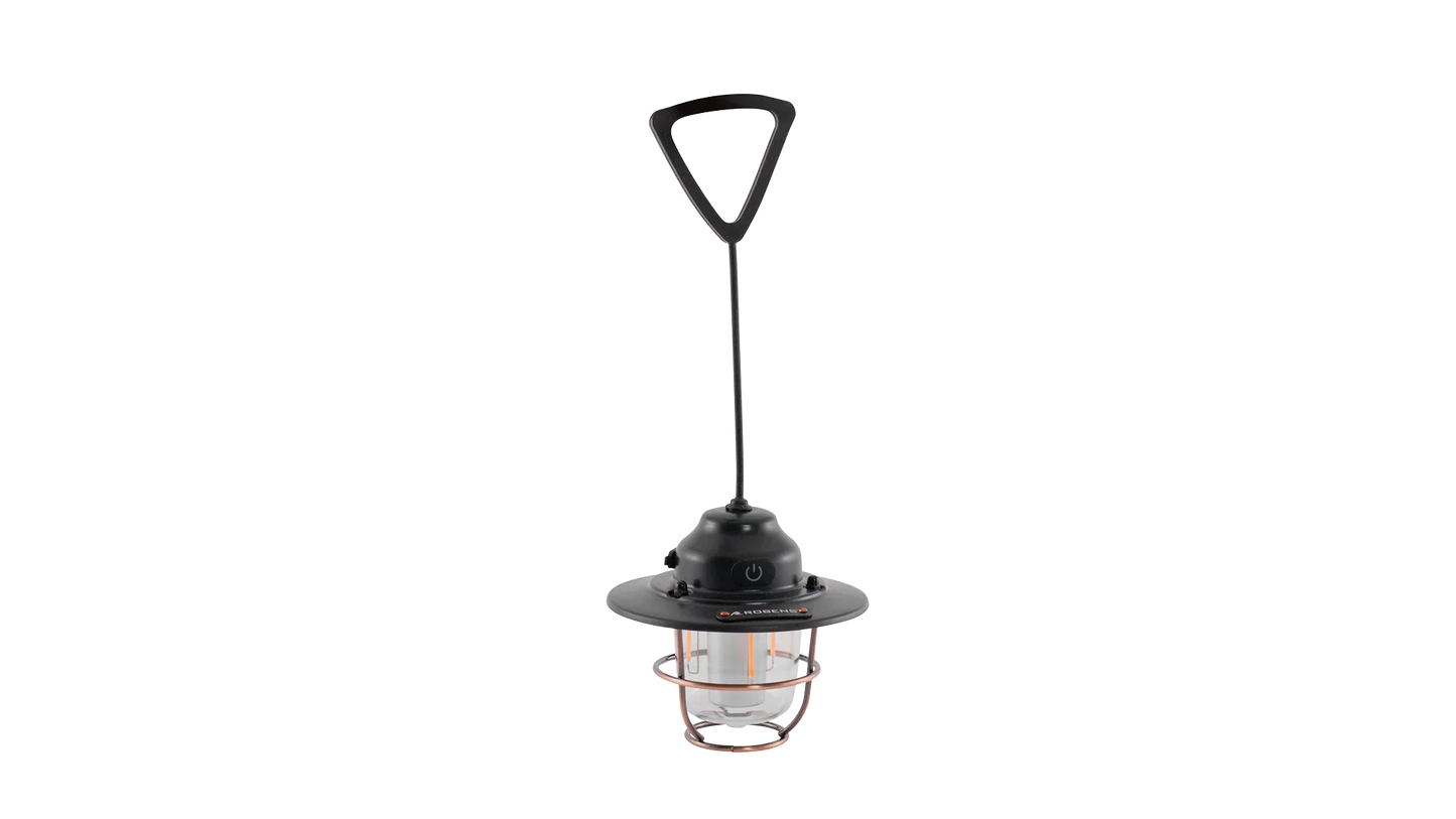 Portable camping lantern with copper cage, black handle, and LED light for outdoor adventures