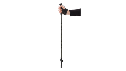 Hand holding adjustable trekking pole with ergonomic grip for hiking and outdoor adventures