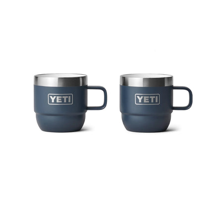 Two navy Yeti insulated mugs with handles, ideal for camping and outdoor adventures.