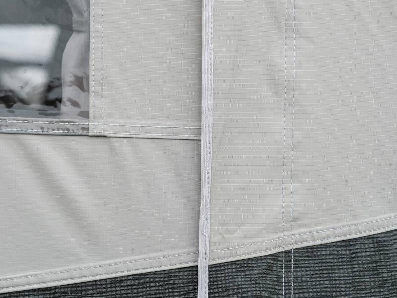 Close-up of durable caravan awning fabric with reinforced stitching and window panel