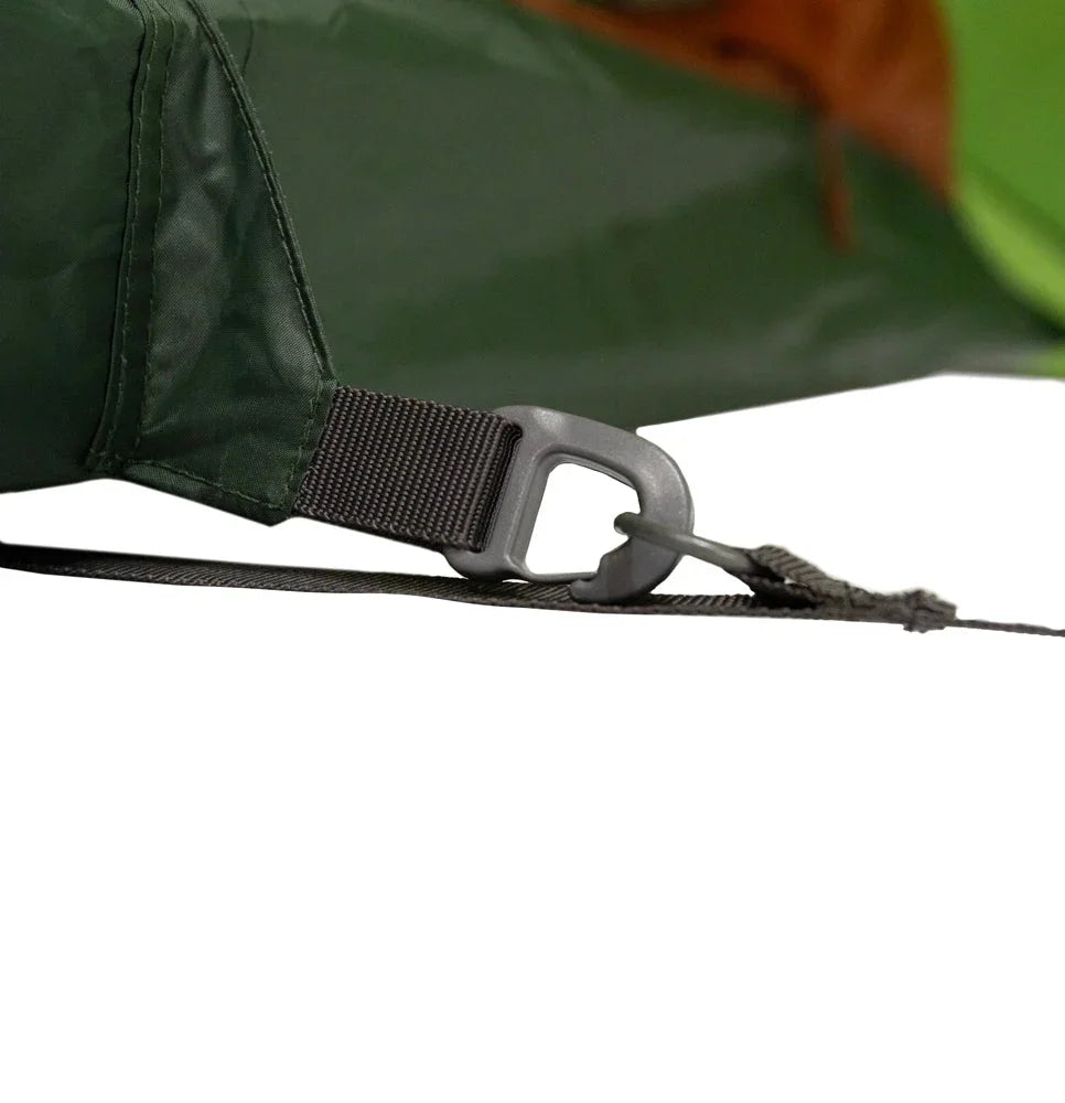 Green tent corner with black strap and plastic buckle for secure camping setup