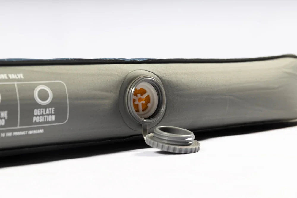 Inflatable camping mattress with deflation valve and cap, ideal for outdoor adventures and caravanning