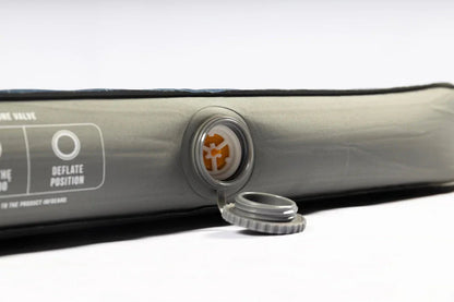 Inflatable camping mattress with deflation valve and cap, ideal for outdoor adventures and caravanning