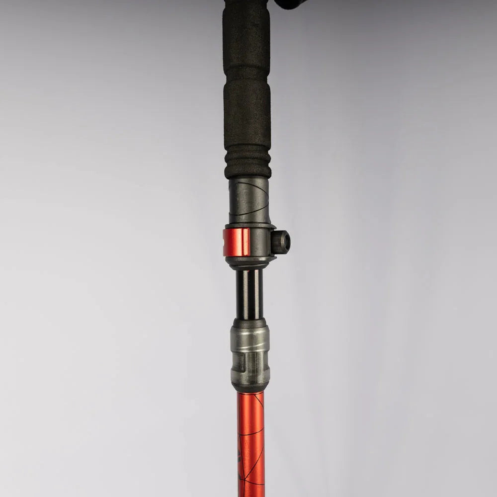 Red and black adjustable hiking pole with ergonomic grip for outdoor adventures