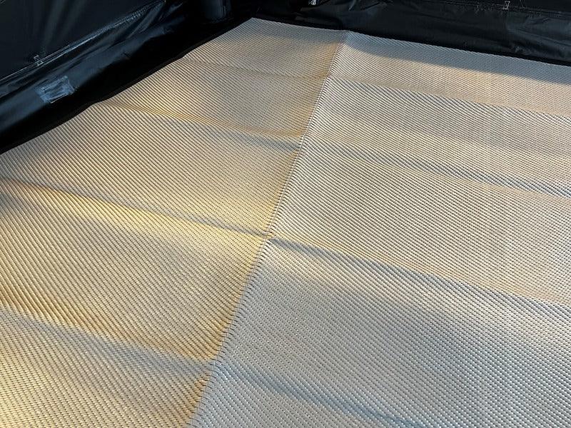 Camping tent floor mat with textured weave for comfort and durability during outdoor adventures.