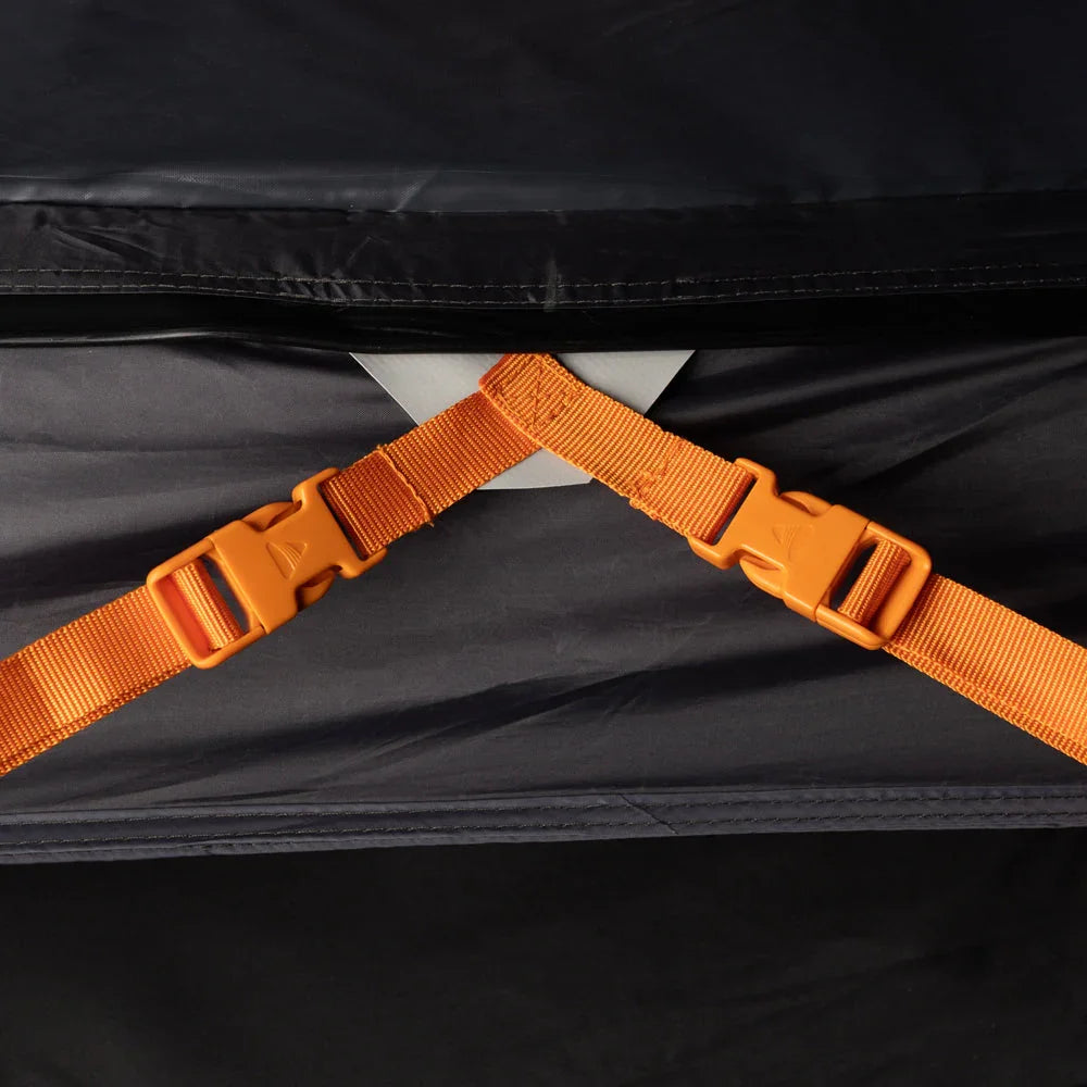 Orange buckles on black camping gear strap for secure outdoor equipment attachment