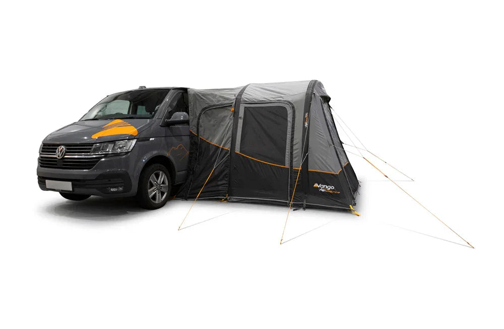 Vango motorhome awning attached to van, ideal for camping & caravan adventures with outdoor gear