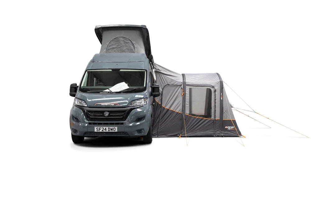 Motorhome with attached awning for camping adventures, featuring spacious outdoor shelter and easy setup.