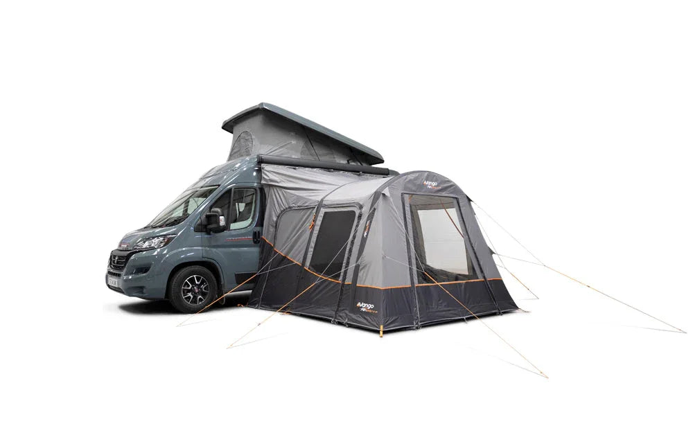 Motorhome awning attached to campervan, featuring pop-up roof and side windows for outdoor camping comfort.