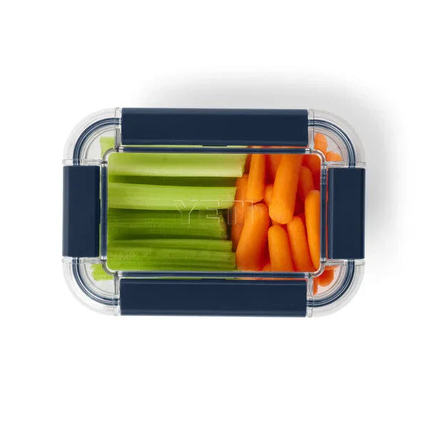 Clear YETI food container with celery and baby carrots, ideal for camping and outdoor adventures
