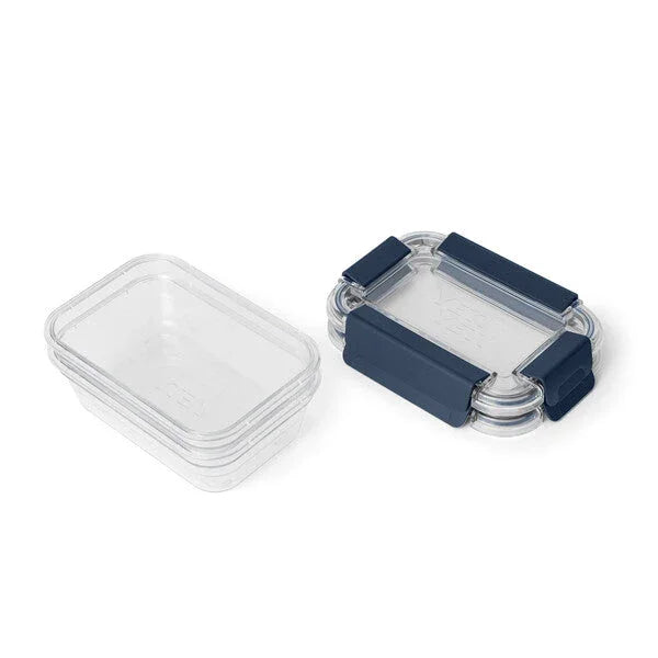 Clear plastic food containers with navy blue lids for camping and outdoor meals