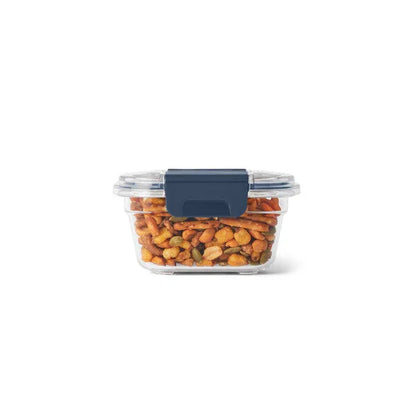 Clear container with blue lid filled with mixed trail nuts for camping snacks