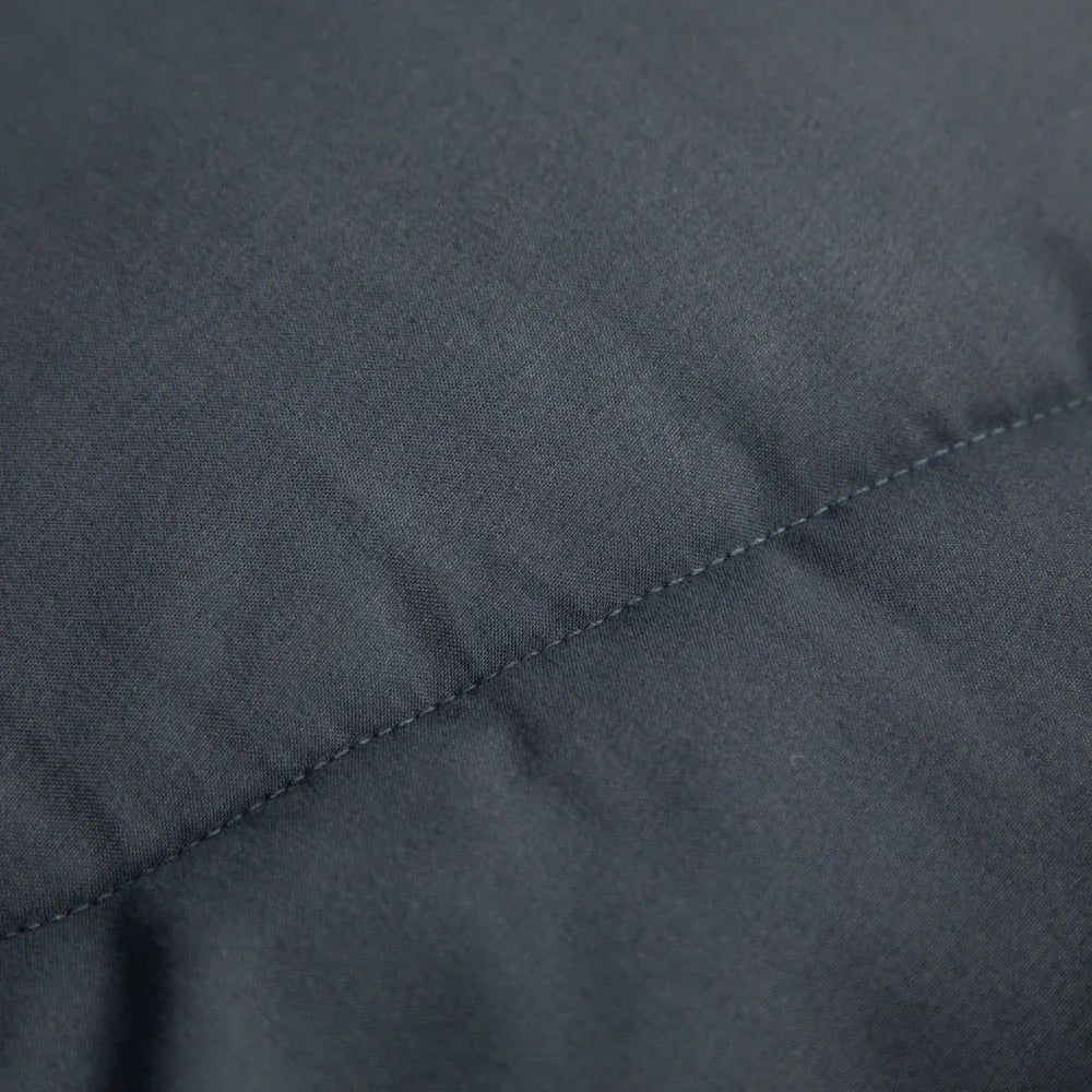 Close-up of durable dark gray fabric with neat stitching, ideal for outdoor gear and camping equipment.