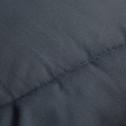 Close-up of durable dark gray fabric with neat stitching, ideal for outdoor gear and camping equipment.