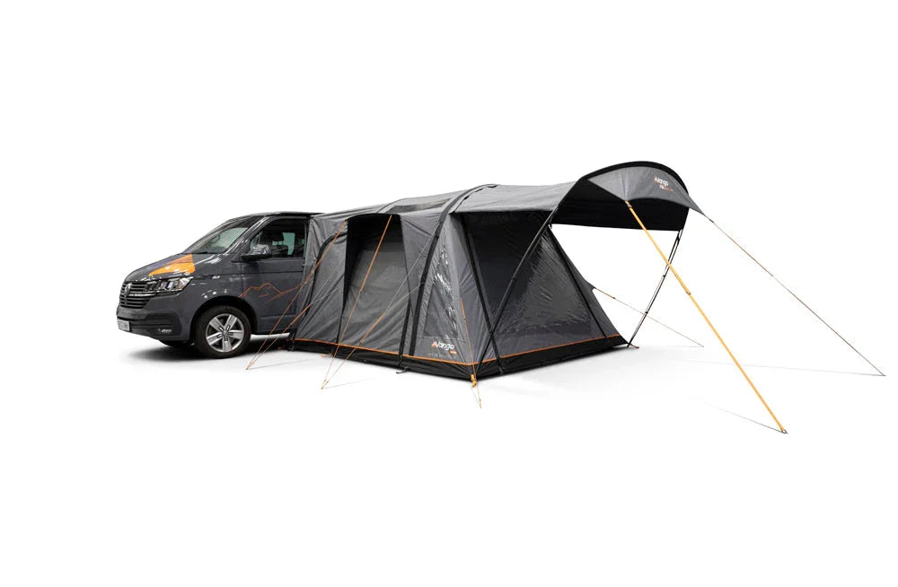 Motorhome awning attached to van, ideal for camping and outdoor adventures with spacious shelter.