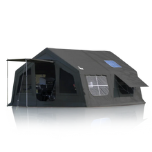 Large black camping tent with awning, windows, and interior furniture for outdoor adventures