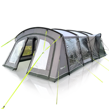Large family camping tent with awning, mesh windows, and bright green guy lines for outdoor adventures.
