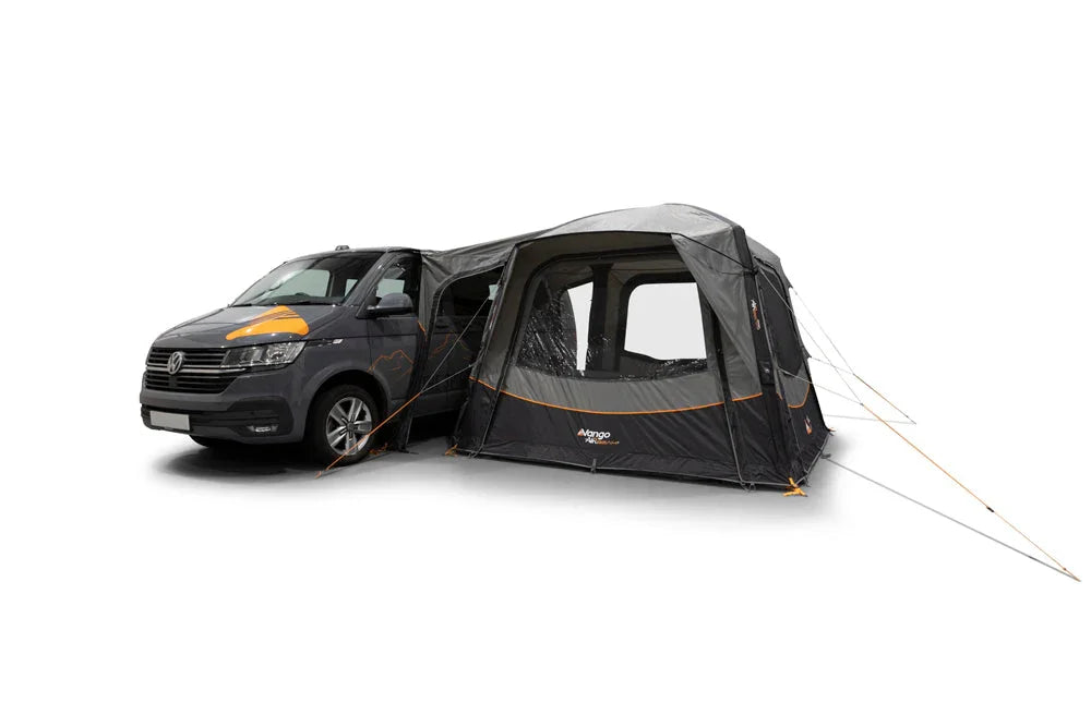 Black and gray motorhome awning attached to van, featuring orange accents and mesh windows for camping adventures.