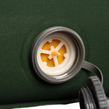 Inflate valve on green camping air mattress for outdoor adventures