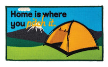 Patch with a tent and 'Home is where you pitch it.' text against a scenic background